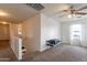 An upper-level spare room offers exercise equipment, ceiling fan, and natural light at 2939 W Sunshine Butte Dr, San Tan Valley, AZ 85144