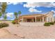 Expansive backyard with a covered patio, low-maintenance desert landscaping, and palm tree accents at 3150 N 150Th Dr, Goodyear, AZ 85395
