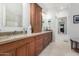 Bright bathroom features dual sinks, spacious vanity, and large mirrors, complemented by a tiled floor at 3150 N 150Th Dr, Goodyear, AZ 85395