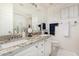 Bright bathroom featuring double sinks, granite countertops, and a glass-enclosed shower at 3150 N 150Th Dr, Goodyear, AZ 85395