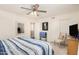 This bedroom features a bed with blue and white linens, a ceiling fan, and a closet at 3150 N 150Th Dr, Goodyear, AZ 85395