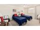 Bright bedroom with two twin beds, blue bedding, patriotic wall art, and a white shuttered window at 3150 N 150Th Dr, Goodyear, AZ 85395