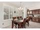 Cozy dining room featuring a wooden table, shuttered windows, and a stylish chandelier at 3150 N 150Th Dr, Goodyear, AZ 85395