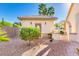 Charming front entrance with a brick pathway, mature landscaping, and a quaint arched doorway at 3150 N 150Th Dr, Goodyear, AZ 85395