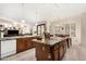 An open-concept kitchen and living area with an island, granite countertops and lots of light at 3150 N 150Th Dr, Goodyear, AZ 85395