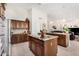 Open kitchen showcasing custom cabinets, granite countertops, and a view into the living area at 3150 N 150Th Dr, Goodyear, AZ 85395
