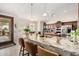 Bright kitchen featuring a large island, stainless steel appliances, and elegant granite countertops at 3150 N 150Th Dr, Goodyear, AZ 85395