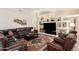 Inviting living room with vaulted ceilings, a stone accent wall, comfortable seating, and neutral paint colors at 3150 N 150Th Dr, Goodyear, AZ 85395