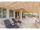 Relaxing outdoor patio with a pergola, comfortable seating, and a view of the landscaped backyard at 3150 N 150Th Dr, Goodyear, AZ 85395