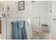 This stylish shower features a pebble floor, shower bench, and a dual shower head, complemented by tiled walls at 3150 N 150Th Dr, Goodyear, AZ 85395