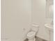 Half bathroom with toilet and sink at 37325 W San Clemente St, Maricopa, AZ 85138