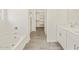 Bright bathroom with a soaking tub, double vanity, and a separate shower at 37325 W San Clemente St, Maricopa, AZ 85138