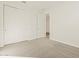 Carpeted bedroom with a window, a closet, and an open door at 37325 W San Clemente St, Maricopa, AZ 85138