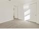 Carpeted bedroom with a window, a closet, and an open door at 37325 W San Clemente St, Maricopa, AZ 85138