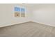 Cozy bedroom with a window providing natural light and neutral carpeting at 37325 W San Clemente St, Maricopa, AZ 85138