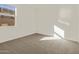Bright bedroom with neutral carpet, window at 37325 W San Clemente St, Maricopa, AZ 85138