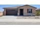 Charming single-story home featuring a two-car garage, stone accents, and low maintenance desert landscaping at 37325 W San Clemente St, Maricopa, AZ 85138