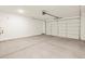 Spacious two car garage featuring a concrete floor and white garage door at 37325 W San Clemente St, Maricopa, AZ 85138