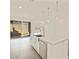 Bright kitchen with tile floors, granite island, and stainless steel appliances at 37325 W San Clemente St, Maricopa, AZ 85138