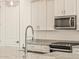 Close-up of a kitchen island with granite countertops, stainless steel appliances, and modern fixtures at 37325 W San Clemente St, Maricopa, AZ 85138