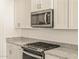 Granite countertops, stainless steel oven, and microwave in this contemporary kitchen at 37325 W San Clemente St, Maricopa, AZ 85138