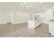 Spacious open-concept living room with island and modern kitchen appliances at 37325 W San Clemente St, Maricopa, AZ 85138