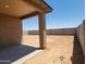 Covered patio overlooking a spacious backyard and block wall fencing at 37325 W San Clemente St, Maricopa, AZ 85138