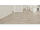 Tile flooring extending throughout a room with a kitchen in the background at 37325 W San Clemente St, Maricopa, AZ 85138