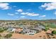 Expansive aerial view of neighborhood featuring well-maintained homes, golf course, and mountain views against a clear blue sky at 3842 E Alameda Ln, Gilbert, AZ 85298