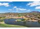 Breathtaking aerial view of the community with its lush golf course, shimmering lake, and scenic desert surroundings at 3842 E Alameda Ln, Gilbert, AZ 85298