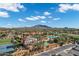 Community amenities include a pool, water slide, tennis court, and lush landscaping, with mountains in the background at 3842 E Alameda Ln, Gilbert, AZ 85298