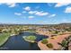 Picturesque aerial view featuring a pristine golf course, serene lake, and luxurious homes in a well-maintained community at 3842 E Alameda Ln, Gilbert, AZ 85298