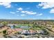 Aerial neighborhood view with a pond and golf course surrounded by homes, offering a picturesque lifestyle with stunning scenery at 3842 E Alameda Ln, Gilbert, AZ 85298
