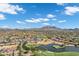 Elevated aerial shot of the community, showcasing the golf course, lake, and the distant mountain range at 3842 E Alameda Ln, Gilbert, AZ 85298