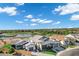 Beautiful aerial view of houses in a community surrounding a pond and golf course on a sunny day with blue skies at 3842 E Alameda Ln, Gilbert, AZ 85298