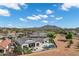 Nice aerial view of the neighborhood featuring a swimming pool, comfortable lounge chairs, patio, and stunning mountain scenery at 3842 E Alameda Ln, Gilbert, AZ 85298