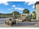 Patio with an outdoor fire pit, ample seating, and views of the lake and surrounding area at 3842 E Alameda Ln, Gilbert, AZ 85298