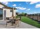 Outdoor dining on a paved patio with artificial grass, perfect for entertaining in style at 3842 E Alameda Ln, Gilbert, AZ 85298