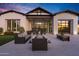 Beautiful outdoor living space featuring comfortable seating, a fire pit, and evening ambiance at 3842 E Alameda Ln, Gilbert, AZ 85298