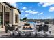 Relaxing backyard with outdoor fire pit, plush seating, and views of the refreshing pool at 3842 E Alameda Ln, Gilbert, AZ 85298