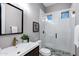 Modern bathroom showcasing a sleek vanity, white subway tile shower with a glass door, and stylish fixtures at 3842 E Alameda Ln, Gilbert, AZ 85298