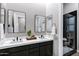 Modern bathroom with dual sinks, a sleek vanity, and a glass-enclosed shower at 3842 E Alameda Ln, Gilbert, AZ 85298