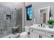 Modern bathroom featuring patterned tile shower, gray walls, and sleek white vanity at 3842 E Alameda Ln, Gilbert, AZ 85298