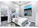Cozy bedroom with gray accents, soft rug, and natural light from a single window at 3842 E Alameda Ln, Gilbert, AZ 85298