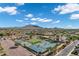Community aerial view of sports courts including tennis, pickle ball, basket ball, and water park set against a mountain view at 3842 E Alameda Ln, Gilbert, AZ 85298