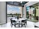A dining area that opens with a retractable glass window to a backyard patio, offering seamless indoor-outdoor living at 3842 E Alameda Ln, Gilbert, AZ 85298