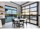 Dining area with floor-to-ceiling windows and a retractable glass wall, blurring the lines between indoor and outdoor spaces at 3842 E Alameda Ln, Gilbert, AZ 85298
