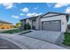 Stylish single-story home featuring a brick driveway, green artificial turf, and a grey garage door at 3842 E Alameda Ln, Gilbert, AZ 85298