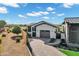 Beautiful home with a brick driveway, a gray garage door, and well manicured landscaping in the front yard at 3842 E Alameda Ln, Gilbert, AZ 85298