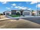 Charming single-story home featuring manicured landscaping, a metal roof, and a welcoming driveway at 3842 E Alameda Ln, Gilbert, AZ 85298